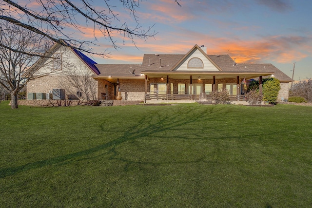 back house at dusk with a yard