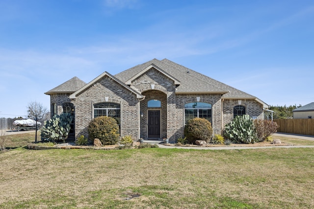 french country home featuring a front lawn