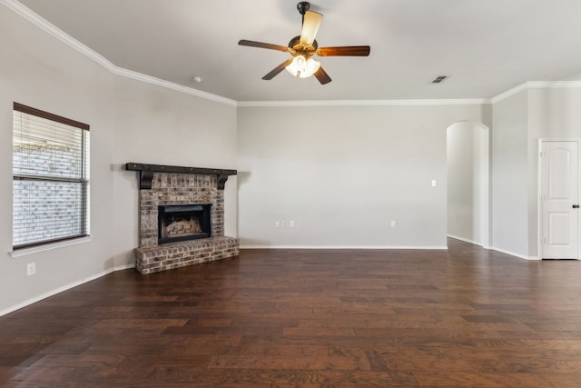 unfurnished living room featuring a fireplace, ornamental molding, and dark hardwood / wood-style floors