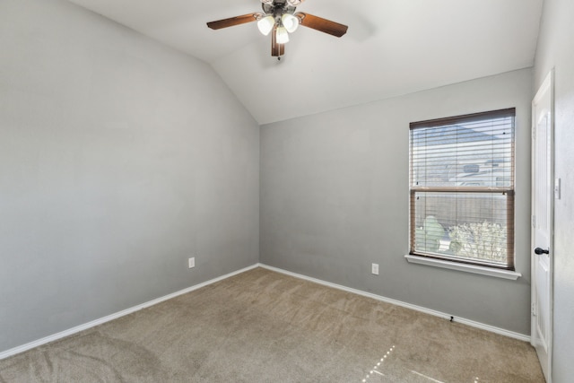 carpeted empty room with ceiling fan and vaulted ceiling