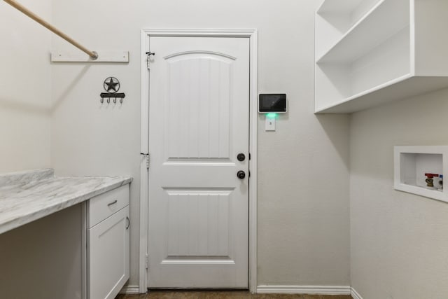 clothes washing area with hookup for a washing machine and cabinets