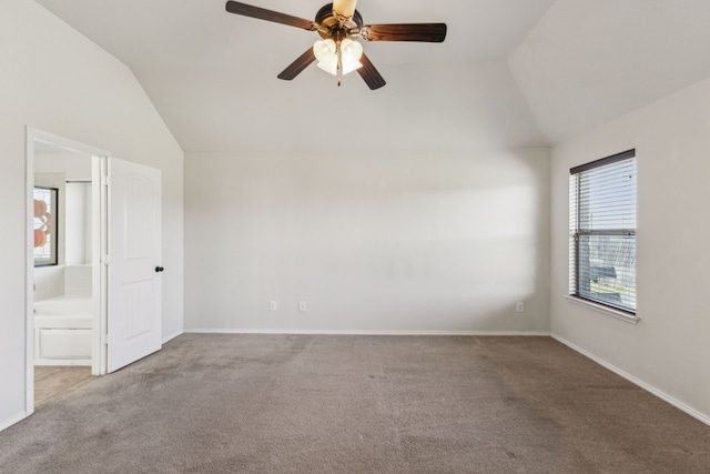 carpeted spare room with lofted ceiling and ceiling fan