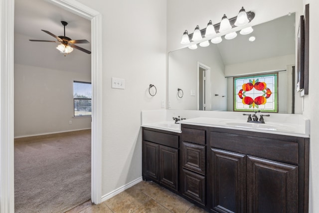 bathroom with tile patterned flooring, vanity, lofted ceiling, and ceiling fan