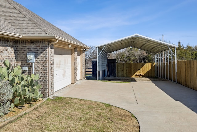 view of patio featuring a carport, a garage, and an outdoor structure