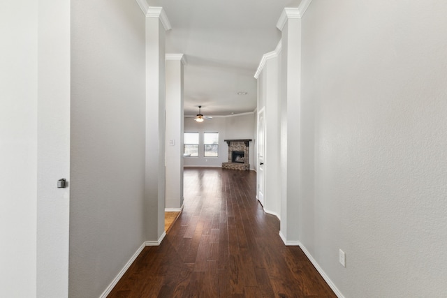 hallway featuring ornamental molding and dark wood-type flooring