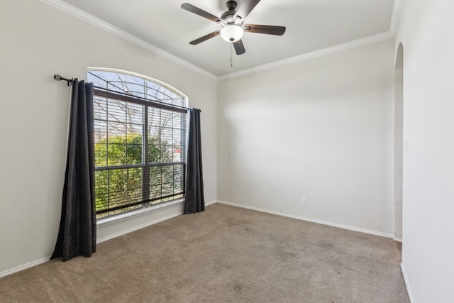 carpeted empty room with crown molding and ceiling fan