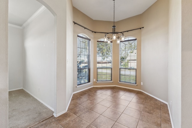 unfurnished dining area featuring light tile patterned floors, crown molding, and a chandelier