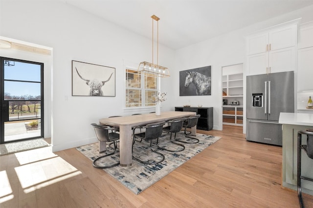 dining space featuring light wood-type flooring