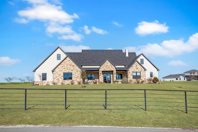 view of front of property featuring a front yard and a rural view