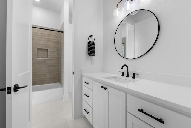 bathroom with vanity and tiled shower / bath combo