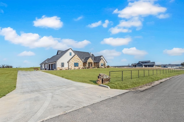 view of front of house with a front yard and a rural view