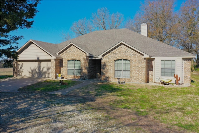 ranch-style home featuring a garage and a front lawn