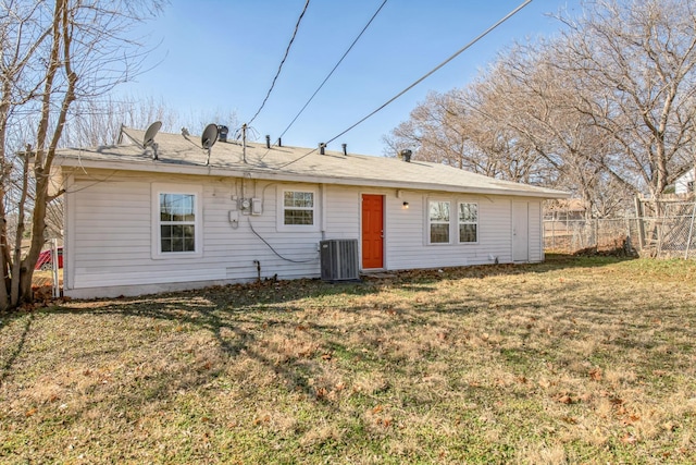 back of house featuring cooling unit and a yard