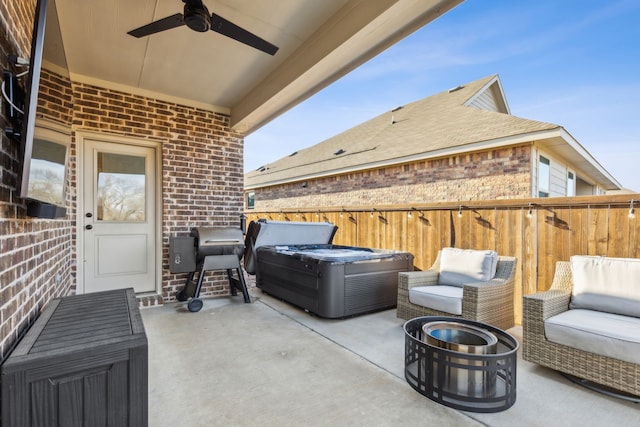 view of patio featuring area for grilling, a hot tub, and ceiling fan