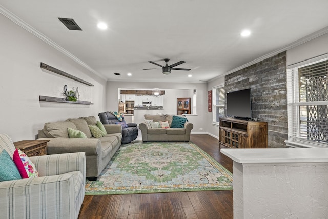 living room with dark hardwood / wood-style flooring, ornamental molding, and ceiling fan