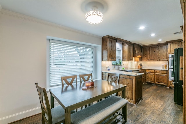 kitchen featuring sink, crown molding, a center island, dark hardwood / wood-style floors, and custom range hood