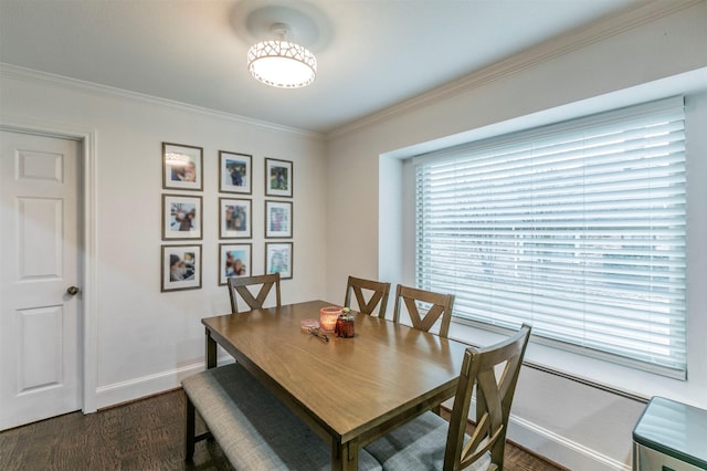 dining space featuring crown molding and dark hardwood / wood-style flooring