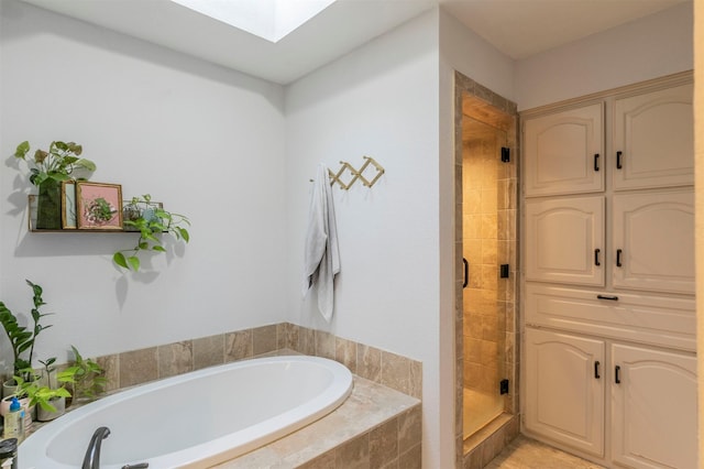 bathroom with plus walk in shower and a skylight