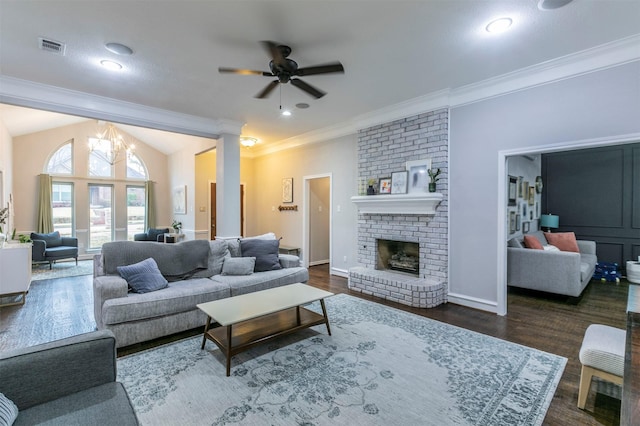 living room featuring lofted ceiling, ornamental molding, dark hardwood / wood-style floors, ceiling fan, and a fireplace