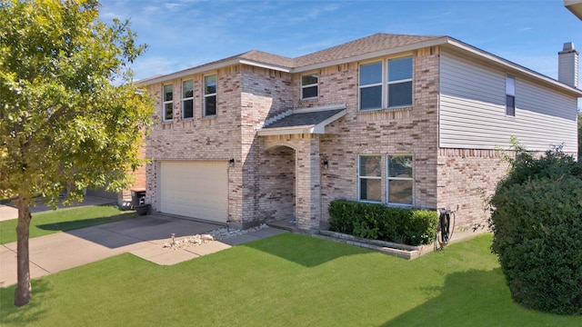 view of front of property featuring a garage and a front yard