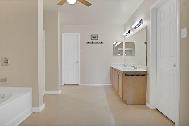 bathroom with vanity, a washtub, and ceiling fan