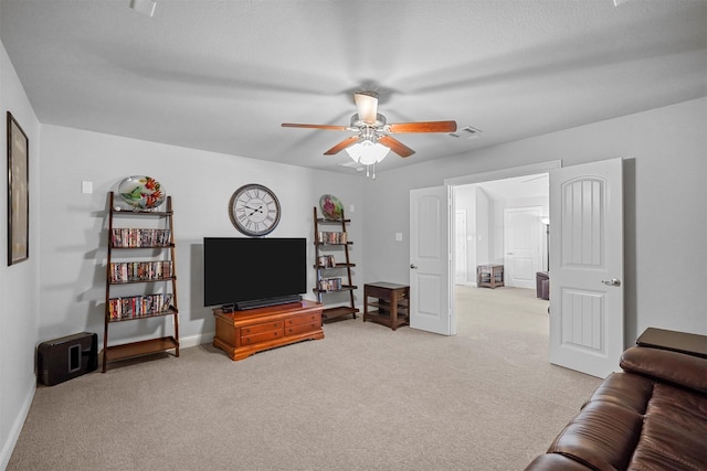 living room with ceiling fan and light colored carpet