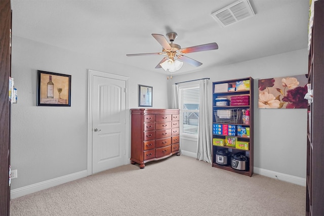 interior space with ceiling fan and light colored carpet