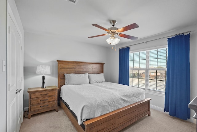 carpeted bedroom with ceiling fan