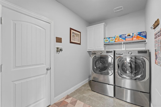 laundry room with cabinets and washing machine and clothes dryer