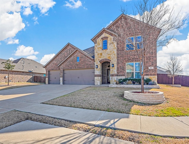 view of front of property featuring a garage and a front lawn