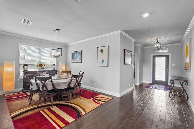 dining area with dark hardwood / wood-style flooring, plenty of natural light, ornamental molding, and a chandelier