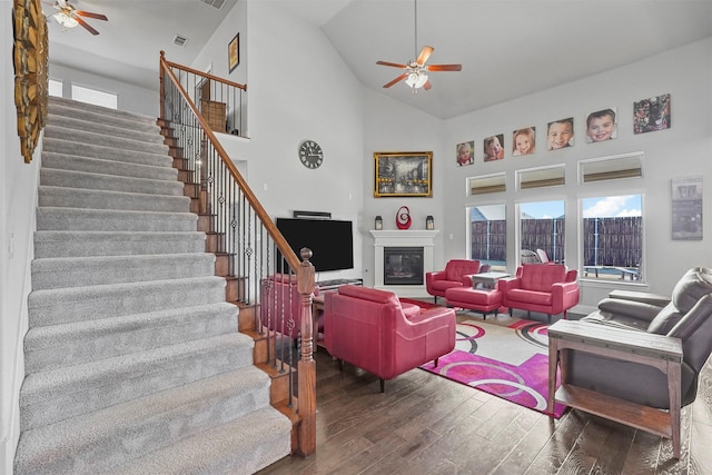 living room with dark hardwood / wood-style flooring, high vaulted ceiling, and ceiling fan