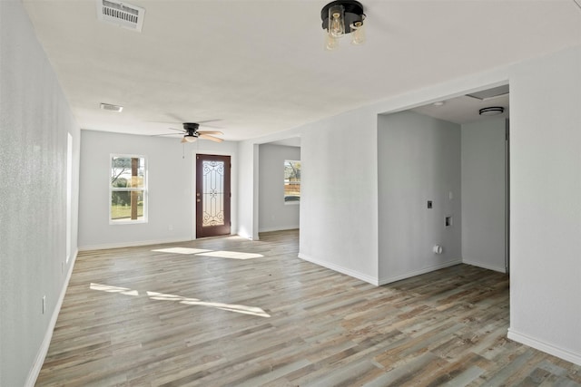 empty room featuring ceiling fan and light hardwood / wood-style flooring