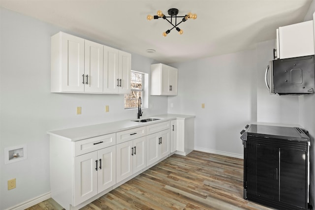 kitchen featuring white cabinetry, sink, and light hardwood / wood-style flooring