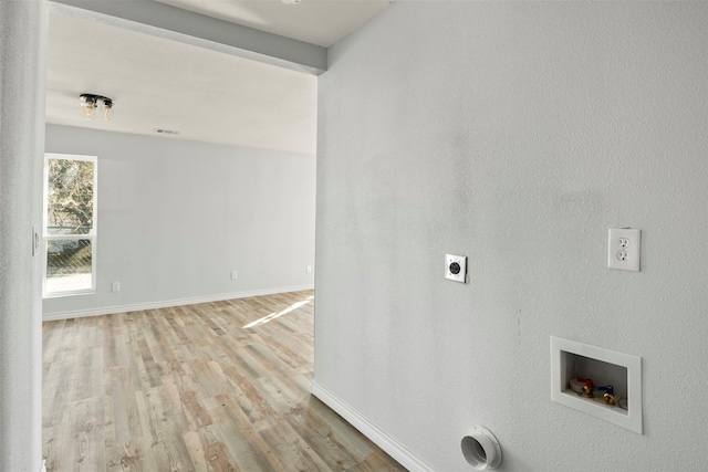 laundry room with hookup for a washing machine, hookup for an electric dryer, and light hardwood / wood-style flooring