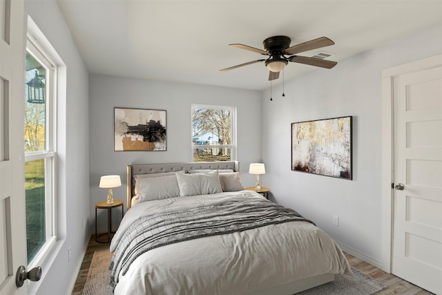 bedroom with ceiling fan and light wood-type flooring