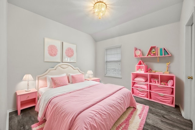 bedroom with vaulted ceiling and dark hardwood / wood-style floors