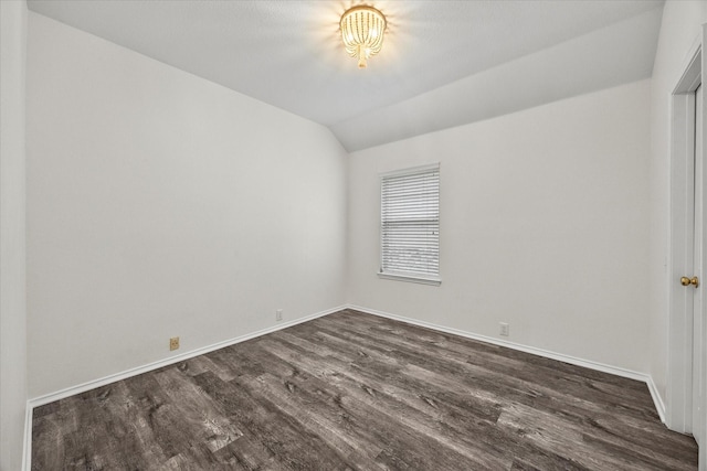 empty room with lofted ceiling and dark wood-type flooring