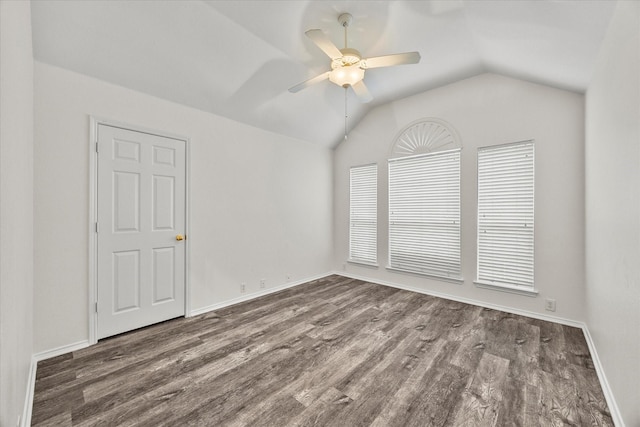 empty room with ceiling fan, lofted ceiling, and dark hardwood / wood-style floors