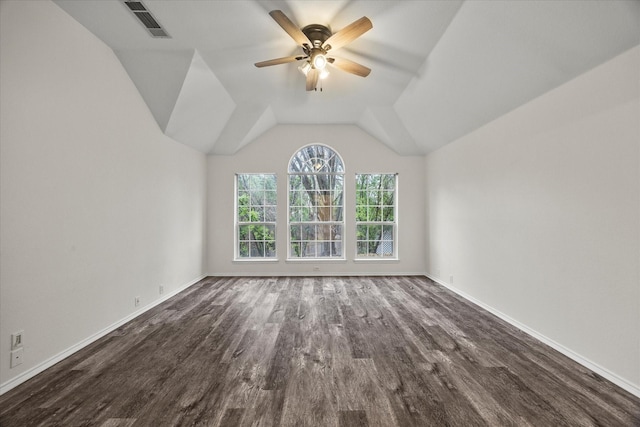 spare room featuring dark hardwood / wood-style flooring, vaulted ceiling, and ceiling fan