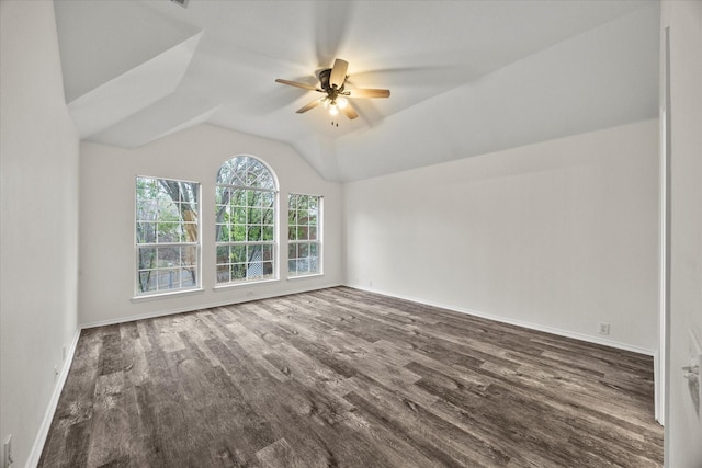 spare room with dark hardwood / wood-style flooring, vaulted ceiling, and ceiling fan