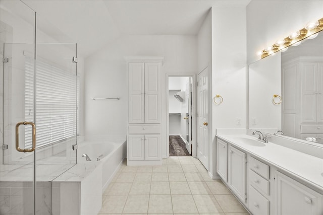 bathroom featuring tile patterned flooring, vanity, separate shower and tub, and vaulted ceiling