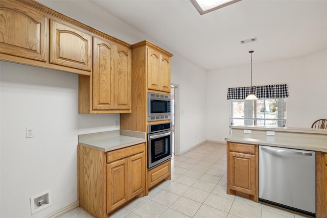 kitchen with stainless steel appliances, hanging light fixtures, and light tile patterned floors