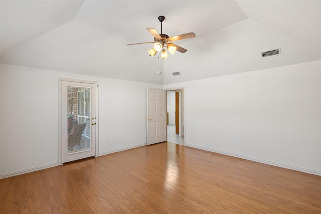 empty room with lofted ceiling, light hardwood / wood-style flooring, and ceiling fan