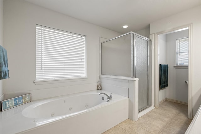 bathroom with a healthy amount of sunlight, separate shower and tub, and tile patterned flooring