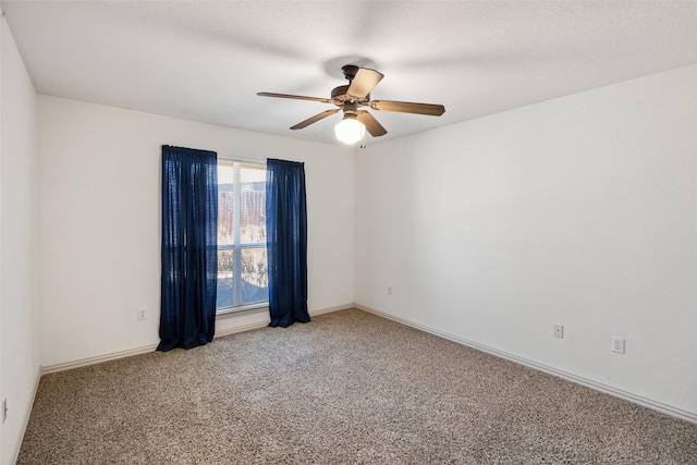 spare room featuring carpet flooring, a textured ceiling, and ceiling fan