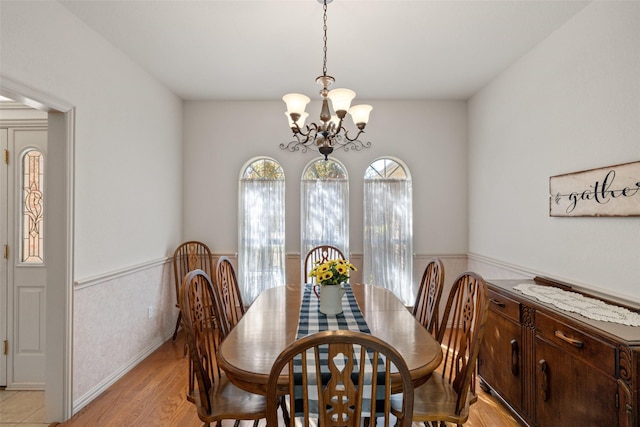 dining room featuring an inviting chandelier and light hardwood / wood-style flooring