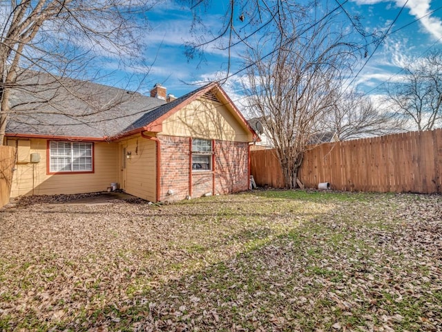 view of side of property with a yard