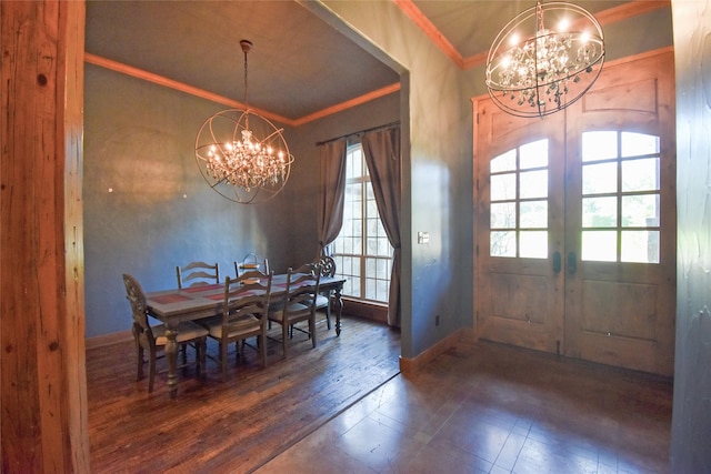 dining area with a notable chandelier, crown molding, dark wood-type flooring, and french doors