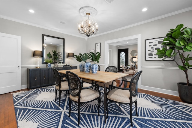 dining space with ornamental molding, dark hardwood / wood-style floors, and a chandelier